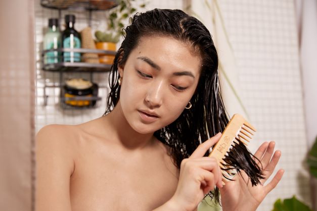 Kvinne grer håret med Detangling Comb